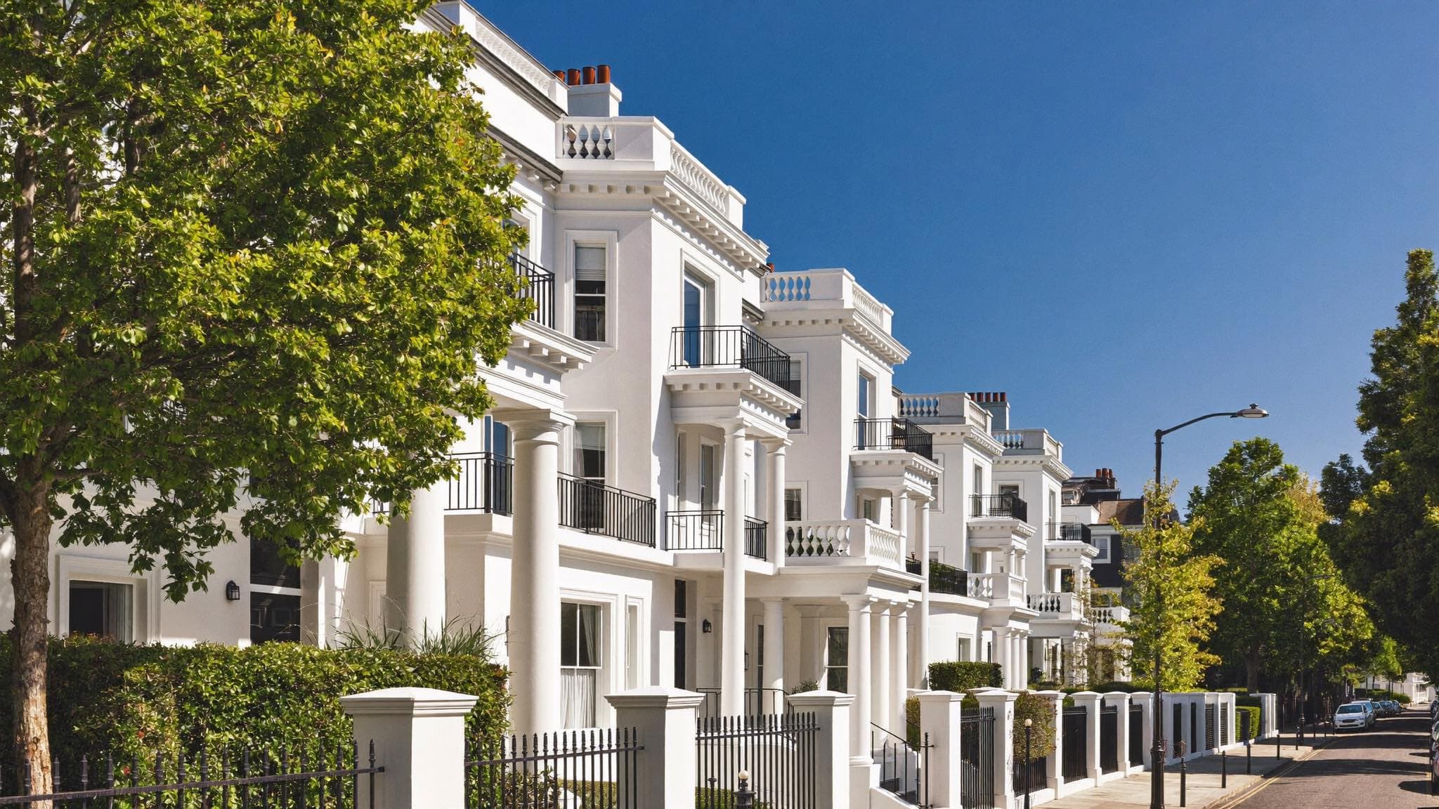 Grand white stucco townhouses on a prestigious London street